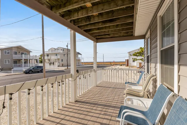 a view of a house with a large window and a ceiling fan