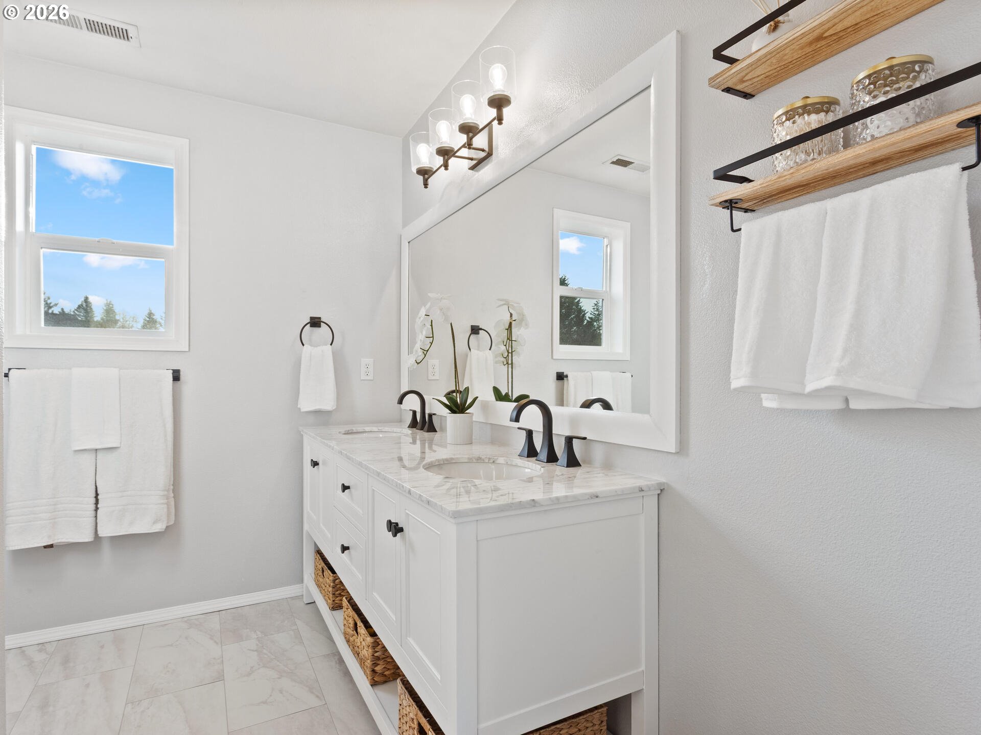 5468 J Street Washougal, WA 98671 - Photo 18 of 48 a bathroom with a double vanity sink a mirror and a shower