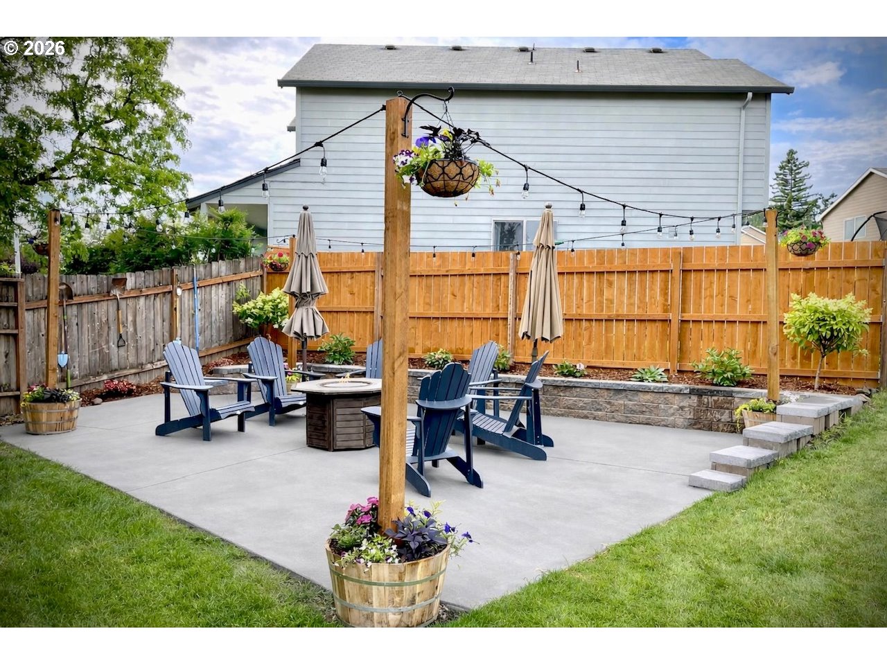 5468 J Street Washougal, WA 98671 - Photo 3 of 48 a view of a patio with table and chairs potted plants and a wooden fence