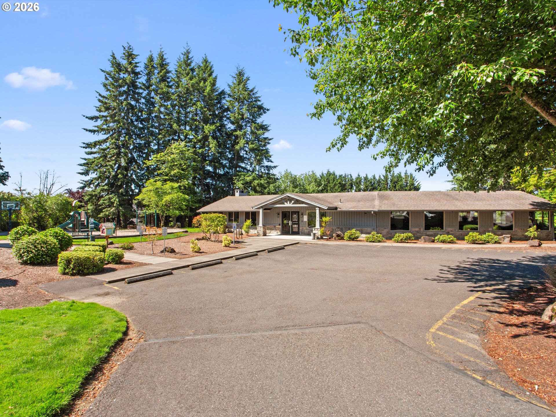5468 J Street Washougal, WA 98671 - Photo 36 of 48 a large white building with a big yard and large trees