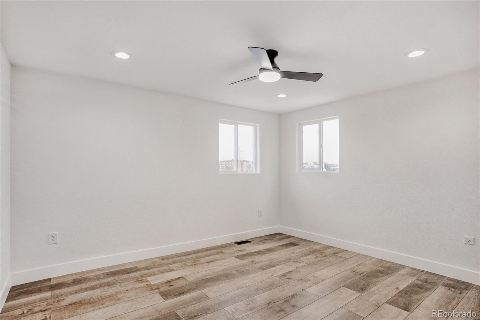 1057 Meade Street Denver, CO 80204 - Photo 12 of 38 a view of empty room with wooden floor and fan
