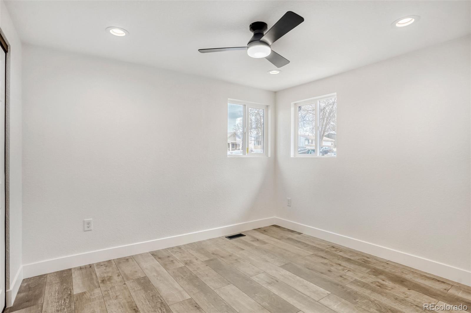1057 Meade Street Denver, CO 80204 - Photo 13 of 38 wooden floor in an empty room with a window