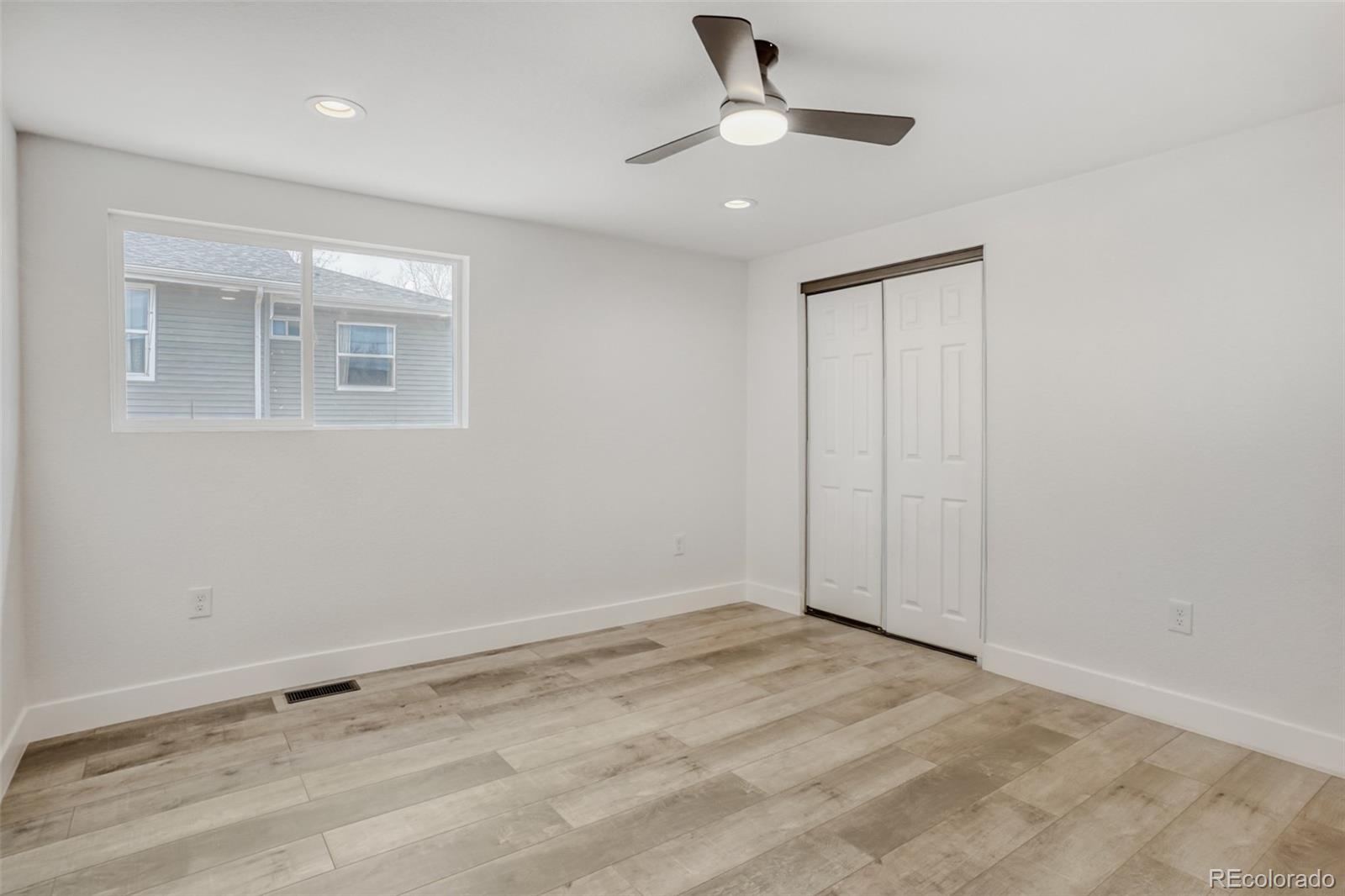 1057 Meade Street Denver, CO 80204 - Photo 15 of 38 an empty room with a ceiling fan