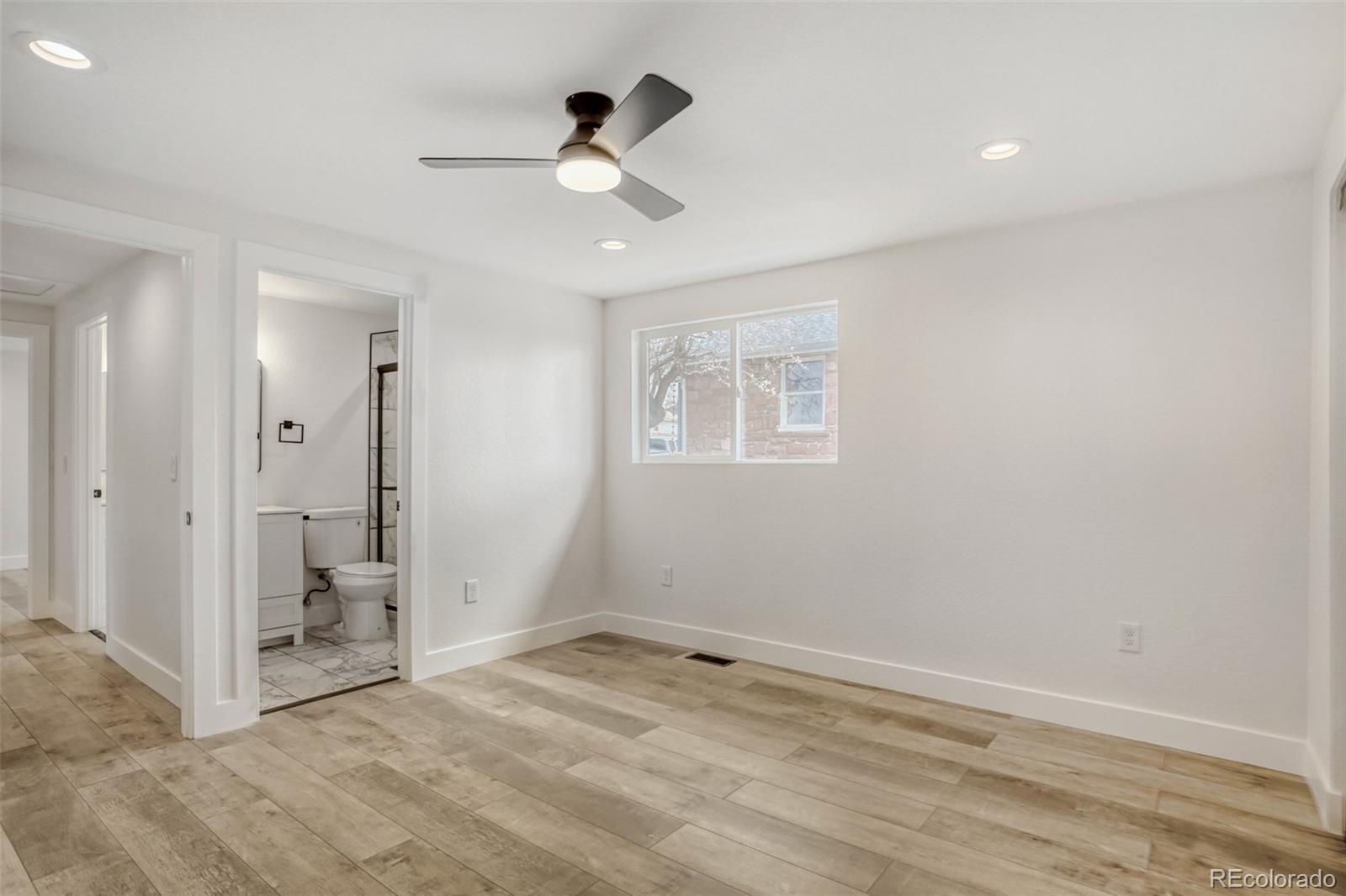 1057 Meade Street Denver, CO 80204 - Photo 16 of 38 an empty room with closet and a chandelier fan