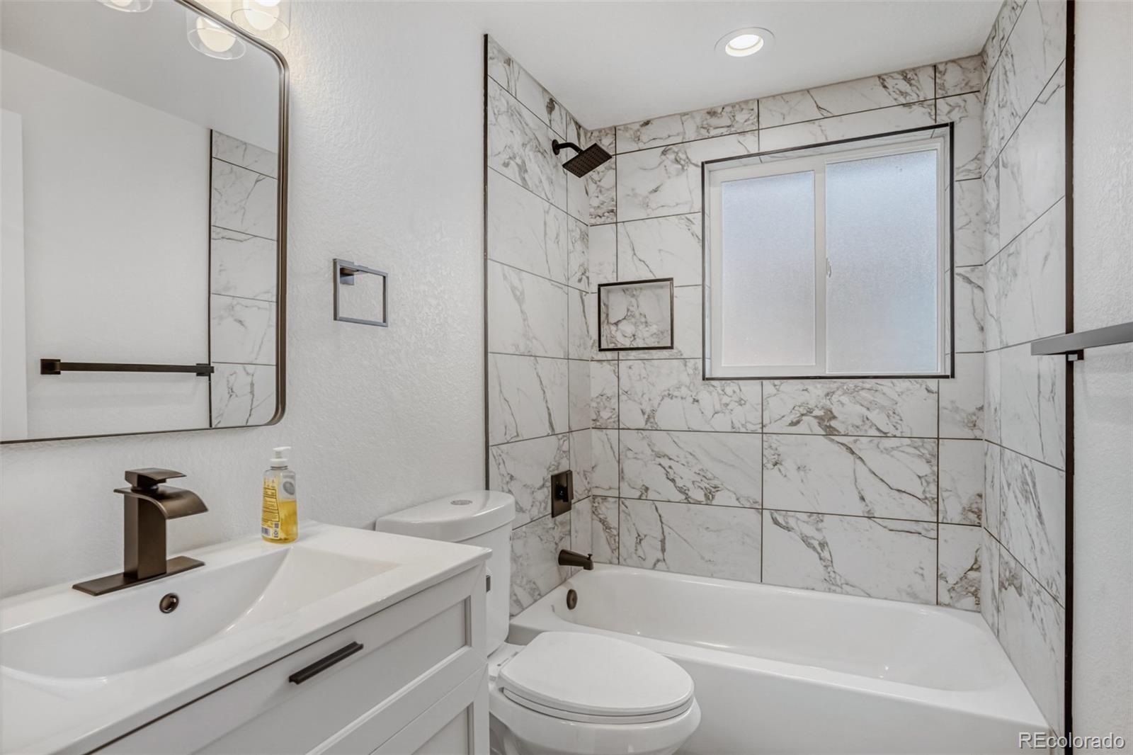1057 Meade Street Denver, CO 80204 - Photo 20 of 38 a bathroom with a sink toilet and shower