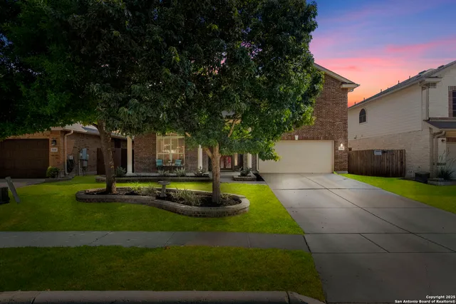 a view of a house with backyard and sitting area