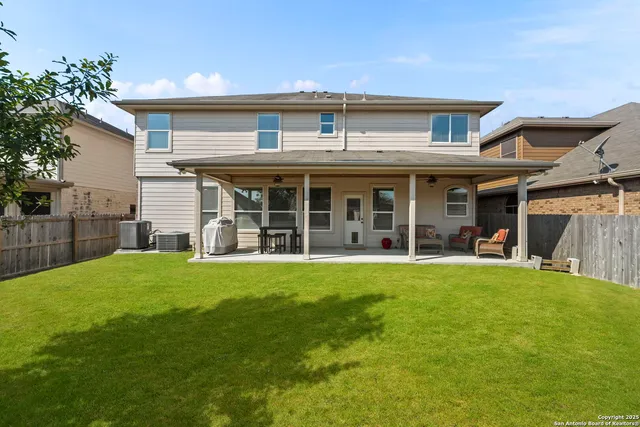a view of a house with a yard and sitting area