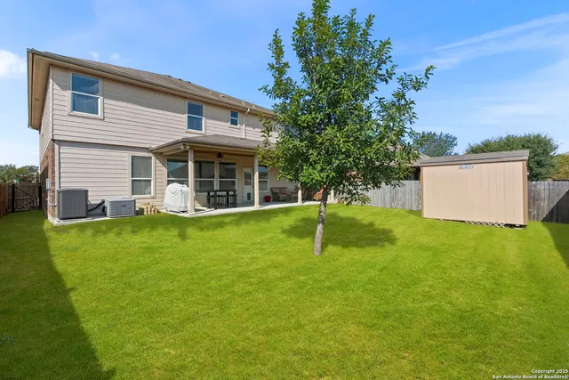 a view of a house with a swimming pool and a big yard