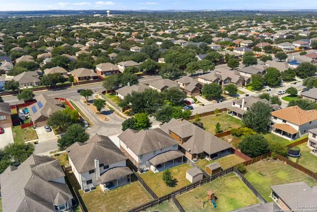 an aerial view of residential houses with outdoor space
