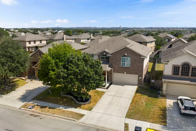 an aerial view of a house with a yard and lake view