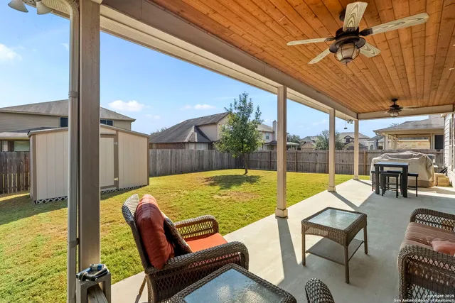 a view of a backyard with a tub and chairs