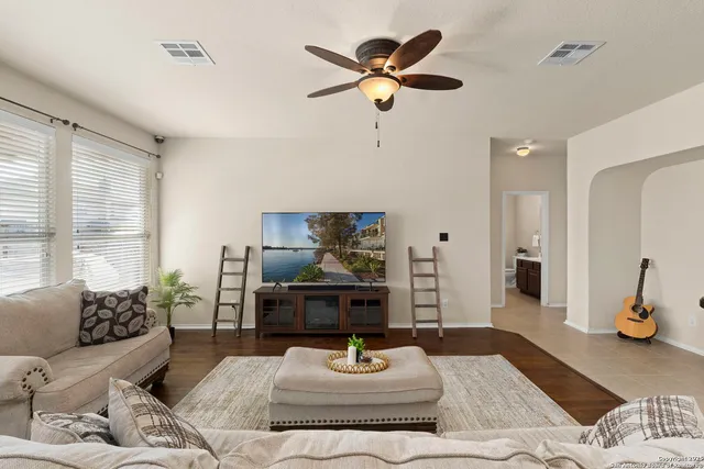 a living room with furniture and a chandelier