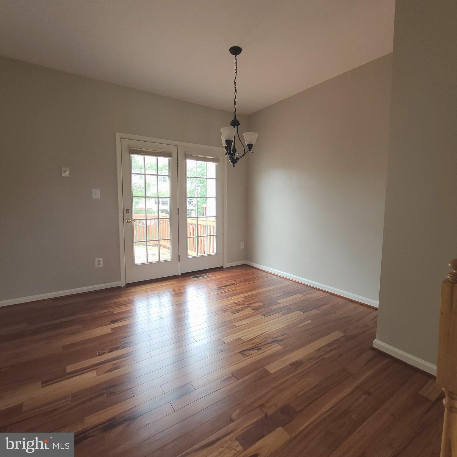 43393 Chokeberry Square Ashburn, VA 20147 - Photo 11 of 31 an empty room with wooden floor and windows