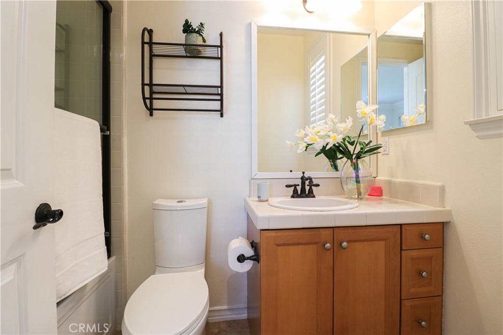 15205 Columbus Square Tustin, CA 92782 - Photo 12 of 43 a bathroom with a sink a toilet and shower