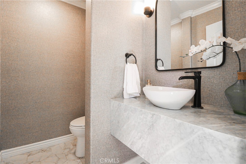 15205 Columbus Square Tustin, CA 92782 - Photo 13 of 43 a bathroom with a toilet and a sink