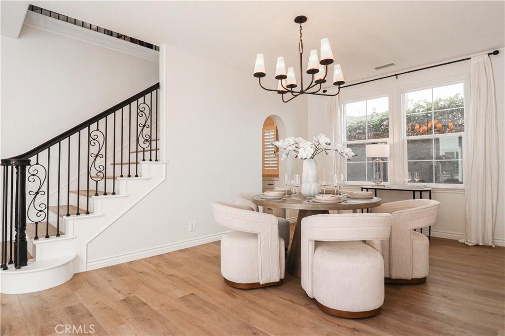 15205 Columbus Square Tustin, CA 92782 - Photo 14 of 43 a room with chandelier fan and wooden floor