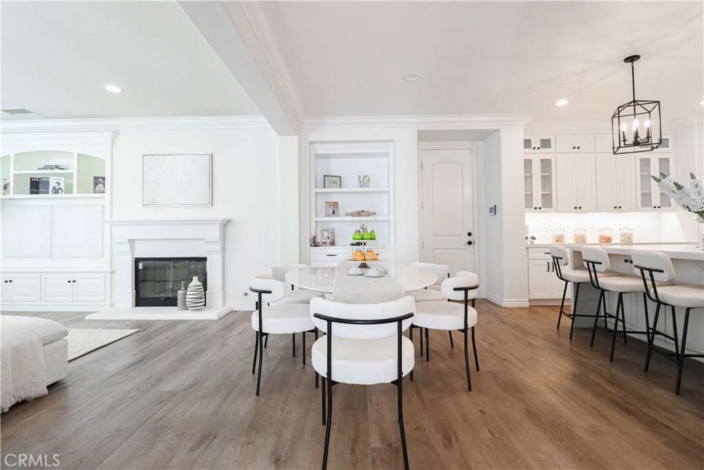 15205 Columbus Square Tustin, CA 92782 - Photo 17 of 43 a view of a dining room with furniture and wooden floor