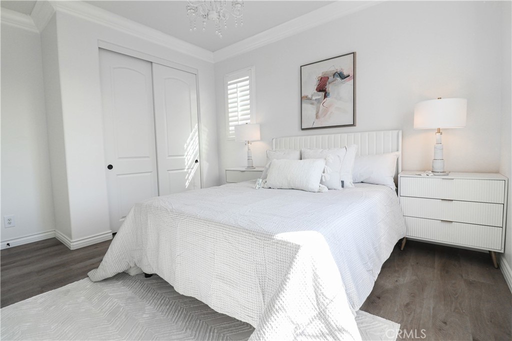 15205 Columbus Square Tustin, CA 92782 - Photo 32 of 43 a bedroom with a bed and a night stand