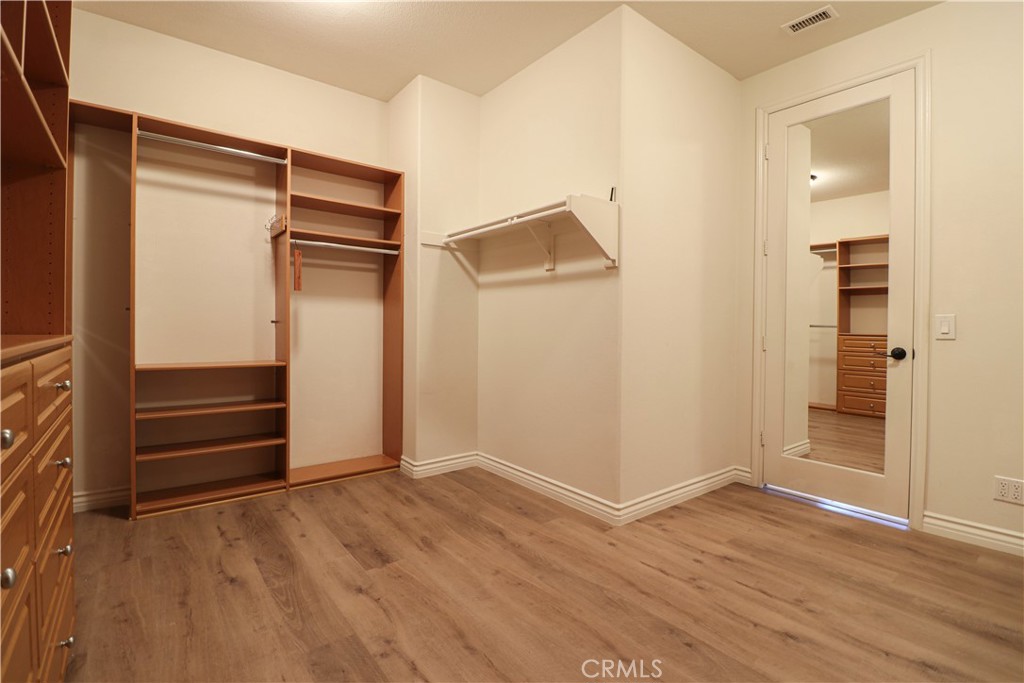15205 Columbus Square Tustin, CA 92782 - Photo 42 of 43 an empty room with wooden floor and closet