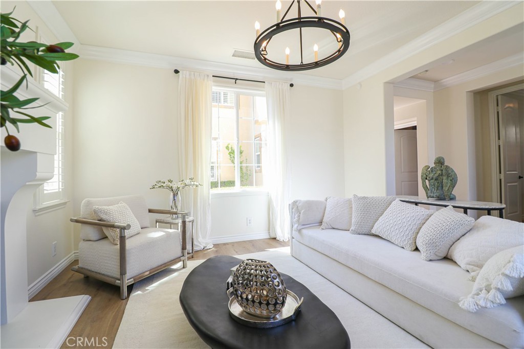 15205 Columbus Square Tustin, CA 92782 - Photo 9 of 43 a living room with furniture a couch and a chandelier