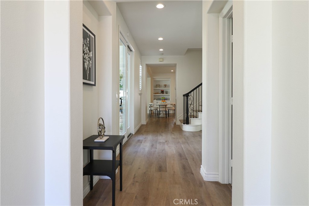 15205 Columbus Square Tustin, CA 92782 - Photo 10 of 43 a view of a hallway and wooden floor in a kitchen