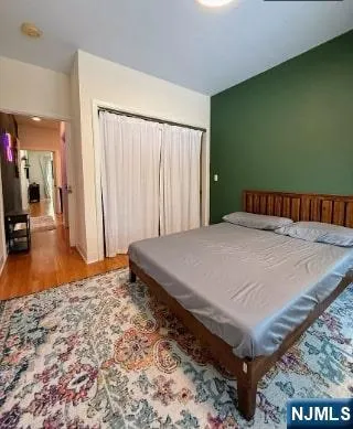 a bed sitting in a spacious bedroom next to a window