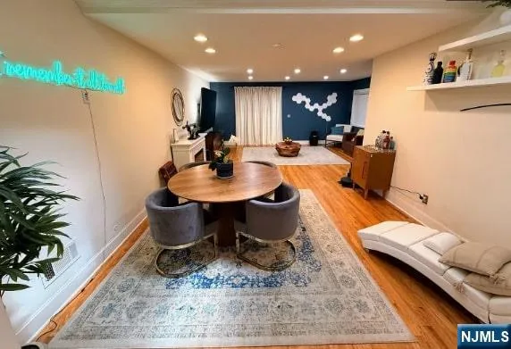 a dining room with furniture and a rug