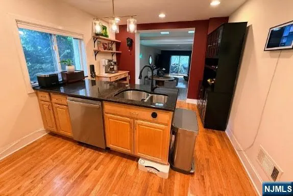 a view of a kitchen with a sink and wooden floor