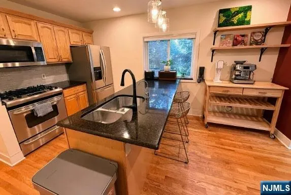 a kitchen with stainless steel appliances granite countertop a stove a refrigerator and a microwave