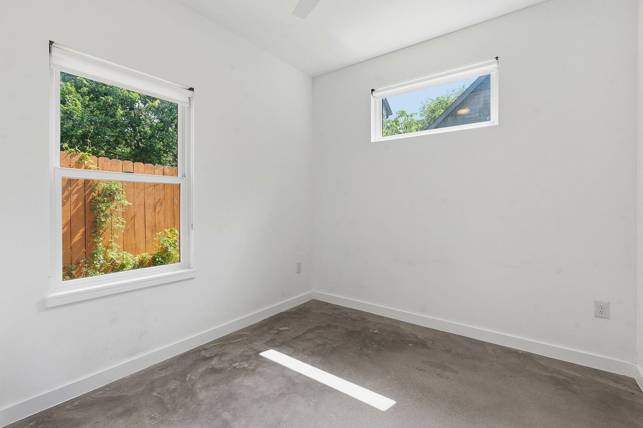 1707 Deloney Street, Unit 2 Austin, TX 78721 - Photo 22 of 26 Concrete floors meet bright windows, inviting in abundant natural illumination for a refreshing ambiance.