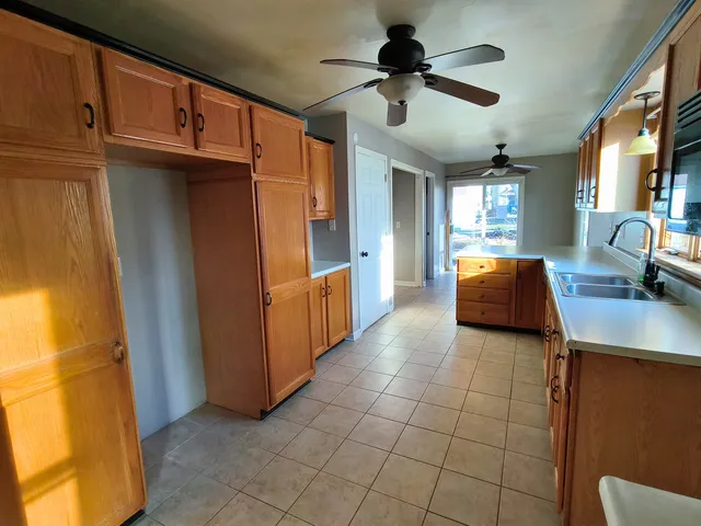 a view of a livingroom with a chandelier furniture and a window