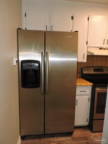 a metallic refrigerator freezer sitting in a kitchen
