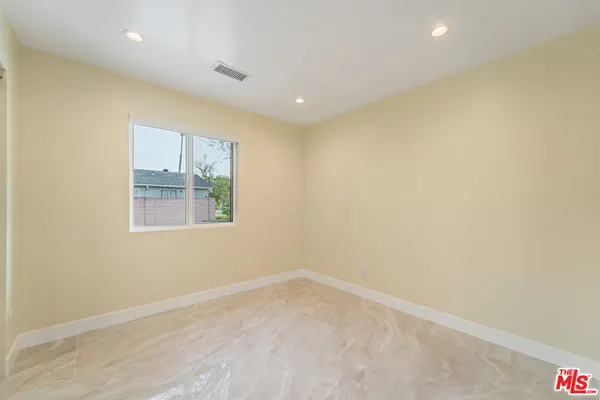 a view of a hallway with wooden floor and closet