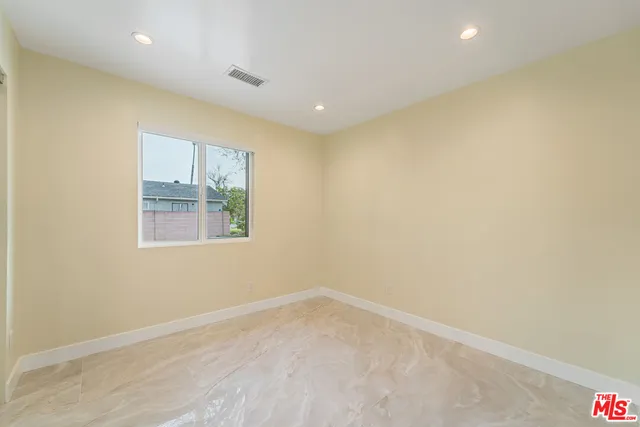 a view of a hallway with wooden floor and closet