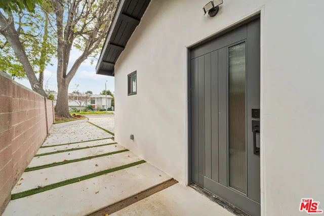 a view of a kitchen with a sink and a washer dryer