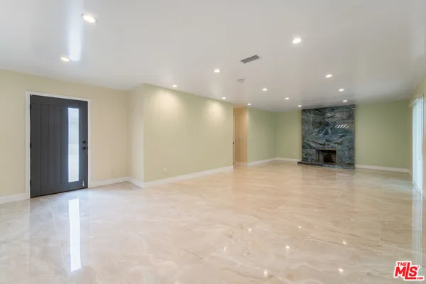 a view of an empty room with a fireplace