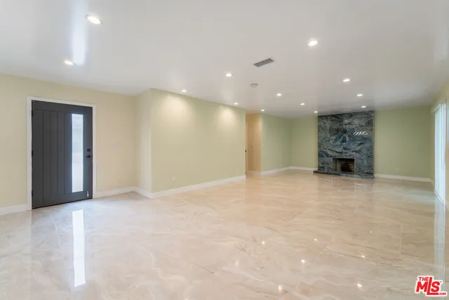 a view of an empty room with a fireplace