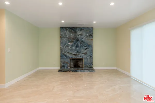 a view of an empty room with a fireplace