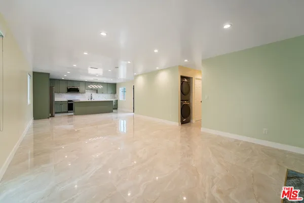 a view of a kitchen with a refrigerator and a sink
