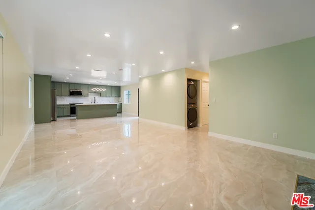 a view of a kitchen with a refrigerator and a sink