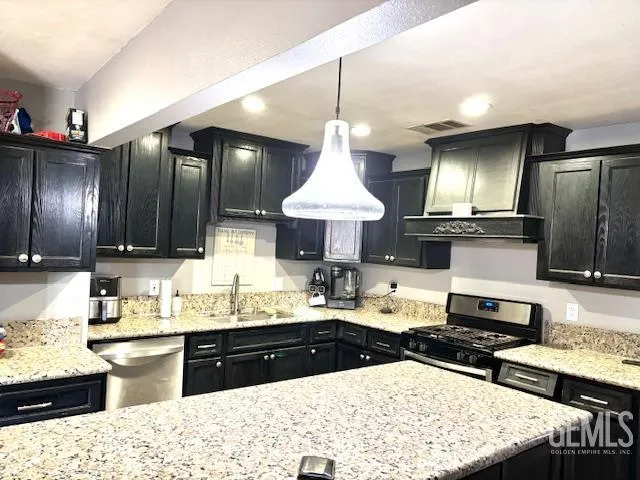 a kitchen with a sink stove and refrigerator