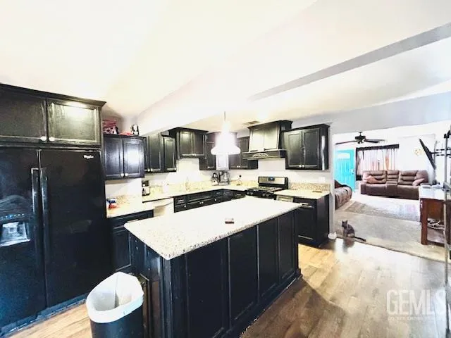 a kitchen with a sink appliances and cabinets