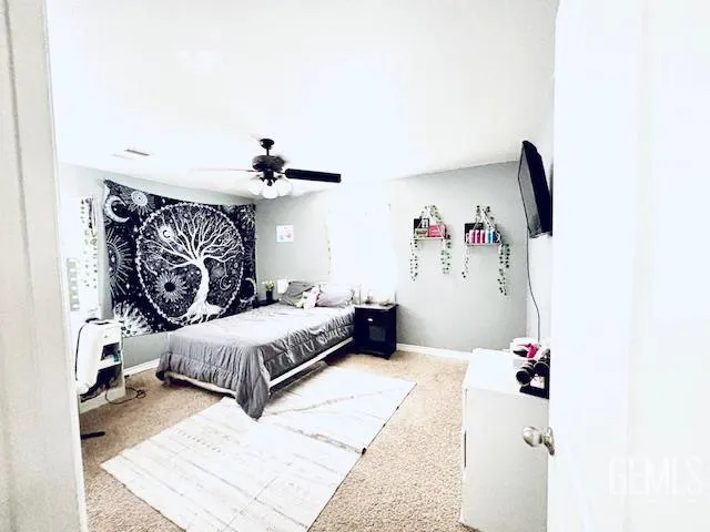 a bedroom with a large bed and a window