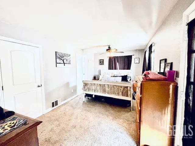 a bedroom with furniture and a flat screen tv