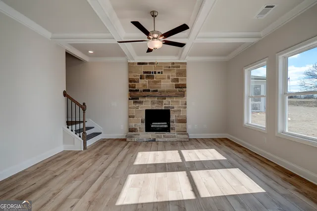 wooden floor in an empty room with a fireplace