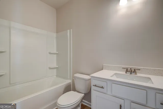 a bathroom with a sink toilet and bathtub