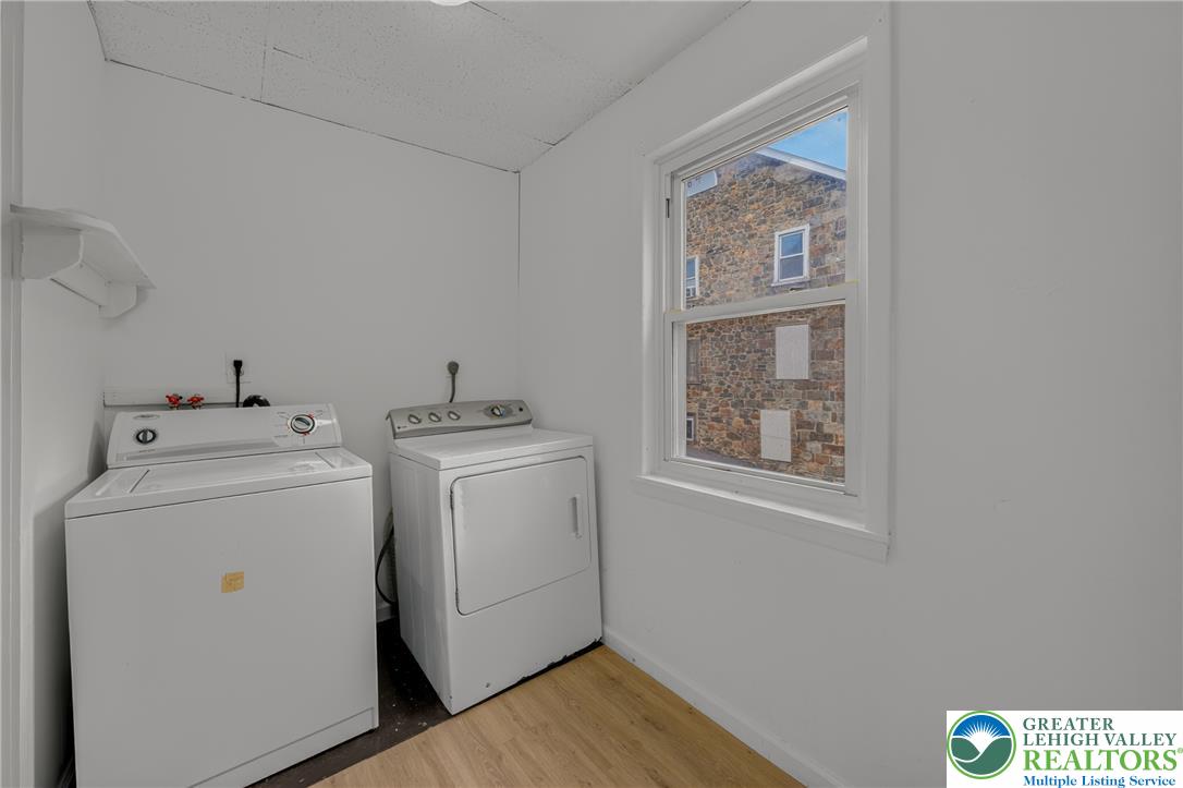 313 Main Street Slatington, PA 18080 - Photo 24 of 73 A well-lit utility room offers convenience with dedicated laundry appliances and a window for natural light.