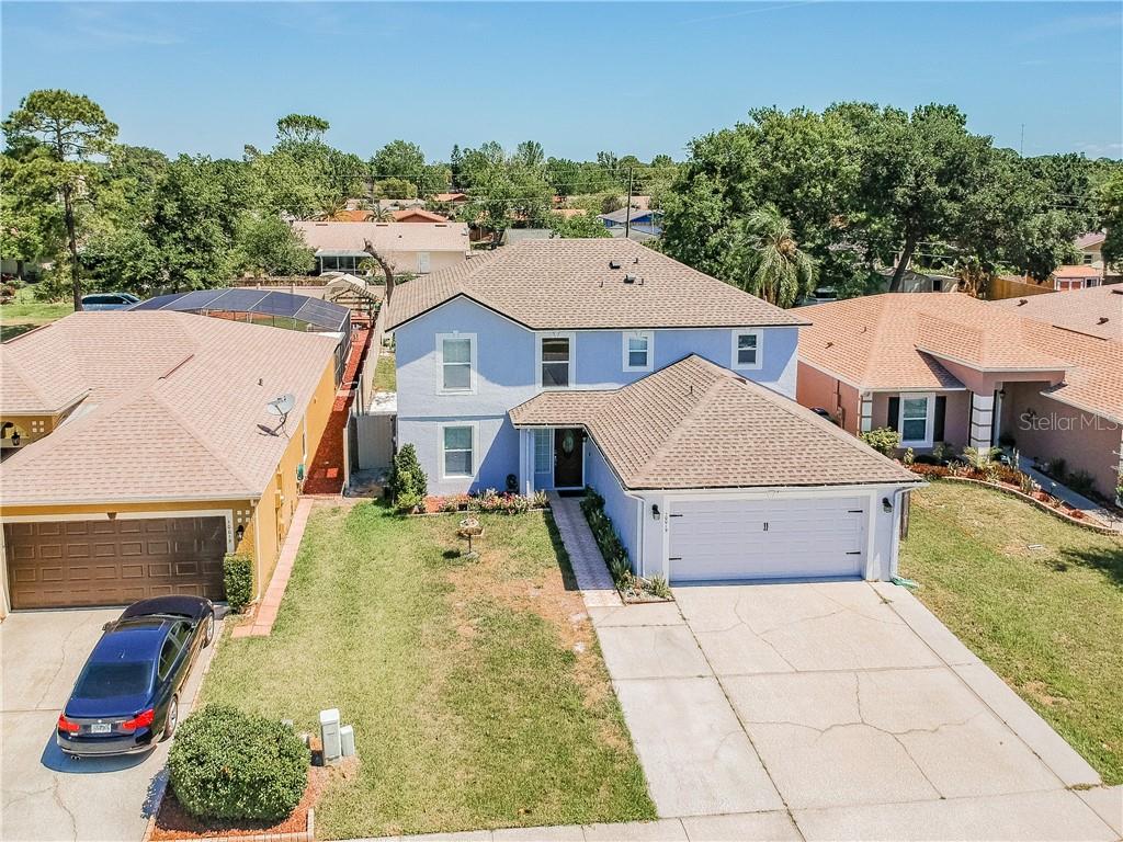 an aerial view of a house with swimming pool and big yard