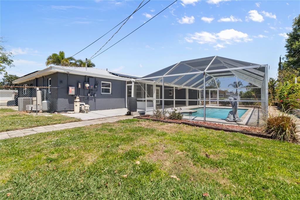 170 Argus Road Venice, FL 34293 - Photo 29 of 34 Spacious backyard with a sparkling in-ground pool, perfect for entertaining, relaxing, or enjoying Florida’s year-round sunshine. Fully fenced with plenty of room to garden, play, or host gatherings—your private outdoor oasis awaits.