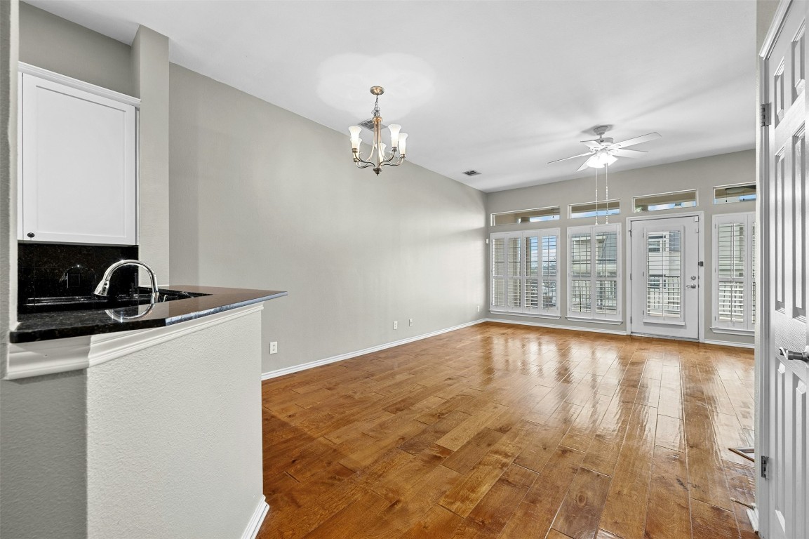 2918 Ranch Road 620 North, Unit W219 Austin, TX 78734 - Photo 13 of 35 a view of an empty room with chandelier fan and wooden floor